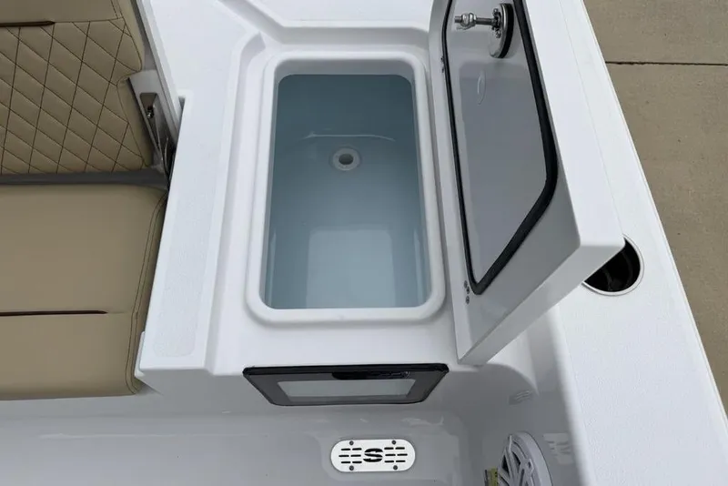 Slide: The Image of Open storage compartment on 2026 Sportsman Masters 227 Bay Boat with cushioned seating. - 23