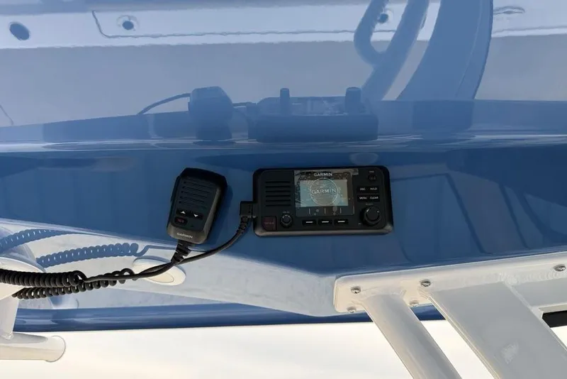Slide: The Image of 2026 Sportsman Masters 227 Bay Boat dashboard with Garmin marine radio and microphone. - 24