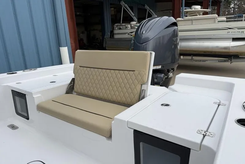 Slide: The Image of 2026 Sportsman Masters 227 Bay Boat with beige seating and powerful outboard motor. - 26