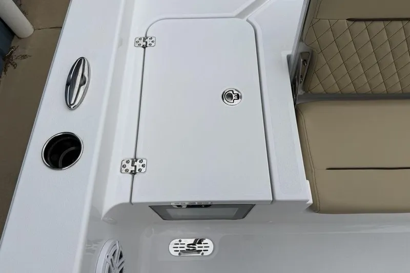 Slide: The Image of 2026 Sportsman Masters 227 Bay Boat interior with storage compartment and cushioned seating. - 28