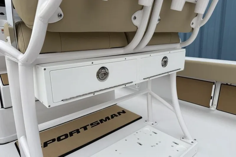 Slide: The Image of 2026 Sportsman Masters 227 Bay Boat seating with storage drawers and beige cushions. - 31