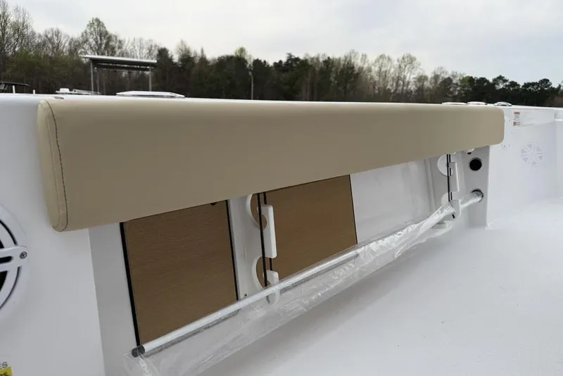 Slide: The Image of 2026 Sportsman Masters 227 Bay Boat interior detail with cushioned seating and storage compartments. - 34