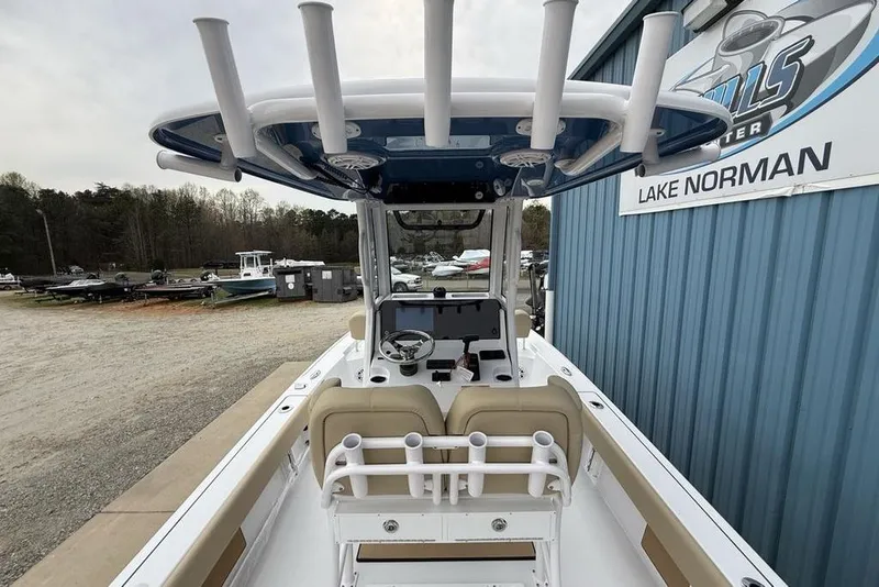Slide: The Image of 2026 Sportsman Masters 227 Bay Boat at Lake Norman dealership, showcasing helm and seating area. - 36
