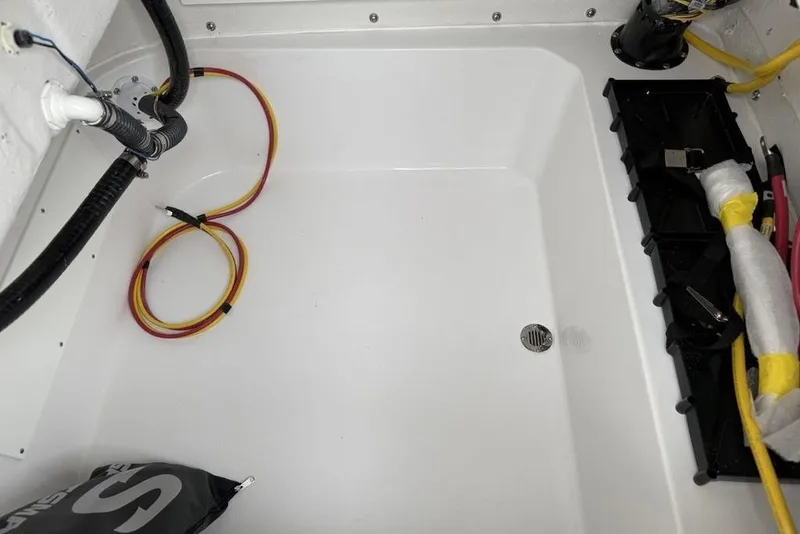 Slide: The Image of Interior view of a 2026 Sportsman Masters 227 Bay Boat, showcasing wiring and drainage. - 37