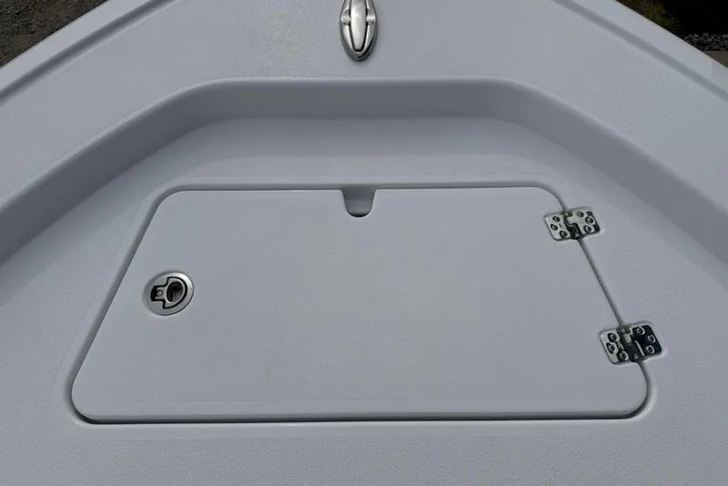 Slide: The Image of 2026 Sportsman Masters 227 Bay Boat storage compartment with secure latch and hinges. - 9