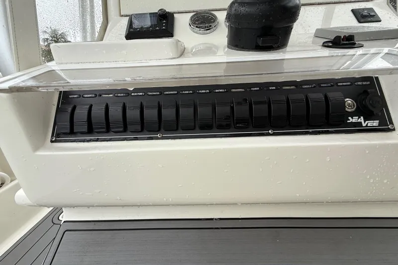 Slide: The Image of Control panel of a 2020 SeaVee 290B boat with switches and gauges. - 10