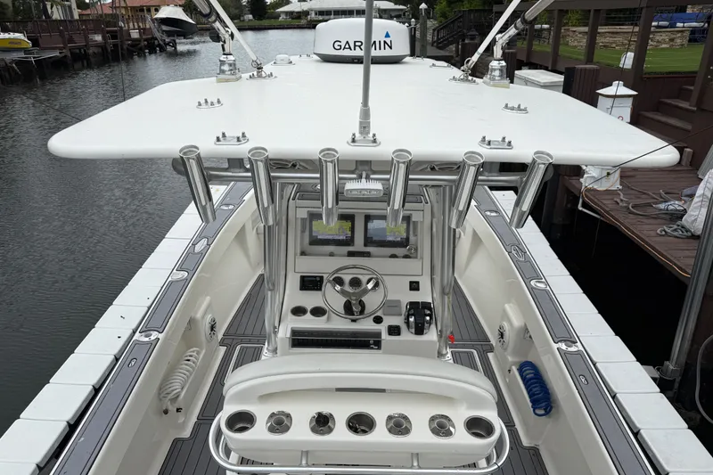 Slide: The Image of 2020 SeaVee 290B boat with advanced Garmin navigation system, docked in a serene marina. - 18