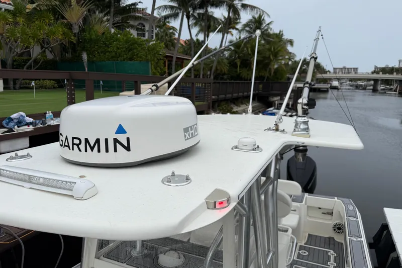 Slide: The Image of 2020 SeaVee 290B boat with Garmin xHD radar, docked near palm trees and waterway. - 19