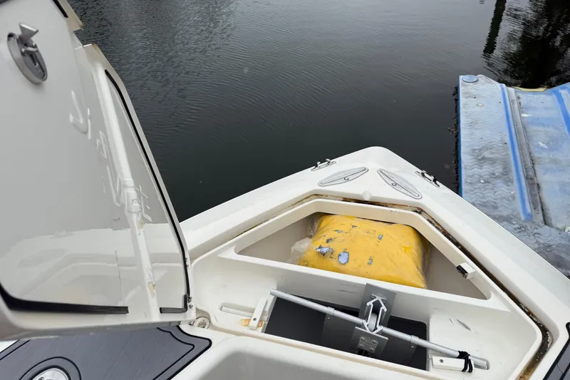 Slide: The Image of 2020 SeaVee 290B boat with open storage compartment near water. - 21