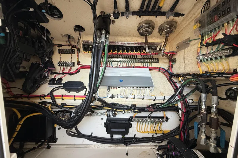 Slide: The Image of Electrical wiring system inside a 2020 SeaVee 290B boat, showcasing organized cables and components. - 29