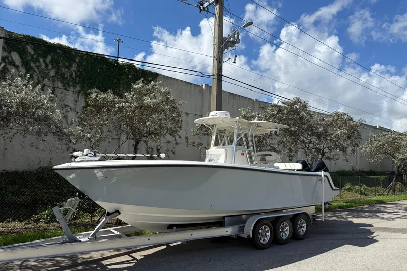 Slide: The Image of 2020 SeaVee 290B boat on trailer, parked outdoors under a blue sky. - 30