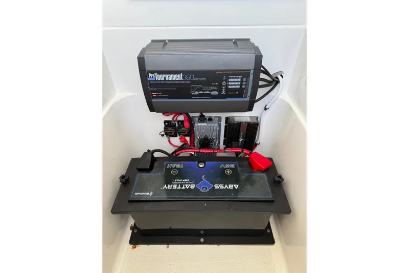 Slide: The Image of 2020 SeaVee 290B boat interior with modern dashboard and seating, docked by the water. - 7