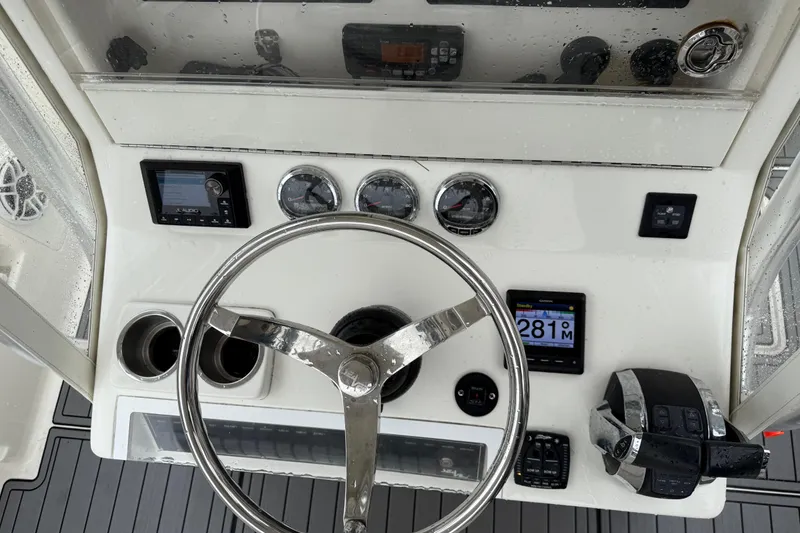 Slide: The Image of 2020 SeaVee 290B boat dashboard with steering wheel, gauges, and navigation controls. - 9