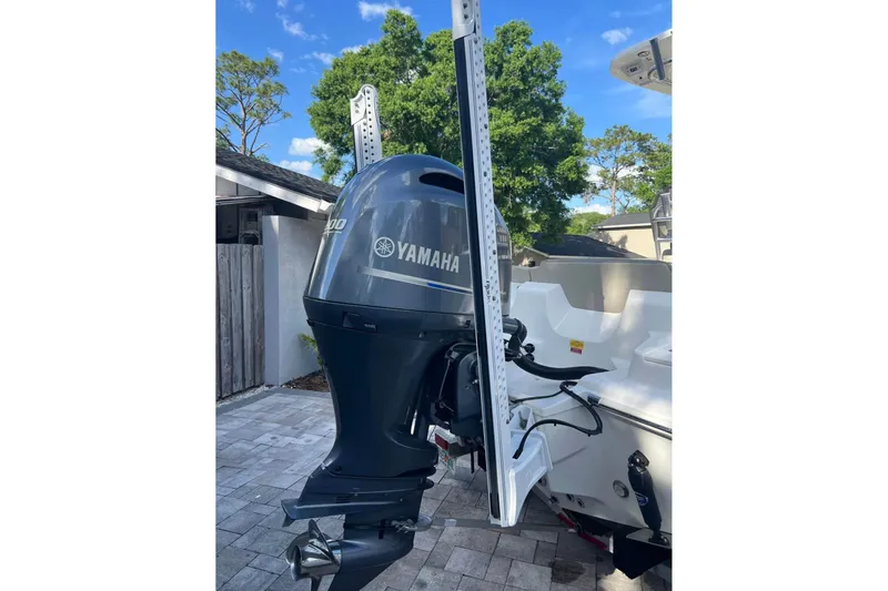 Slide: The Image of 2022 Key West 219 FS boat with Yamaha outboard motor, parked outdoors. - 10
