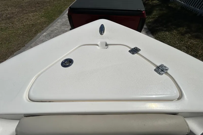 Slide: The Image of 2022 Key West 219 FS boat deck with storage compartment and hinges. - 100