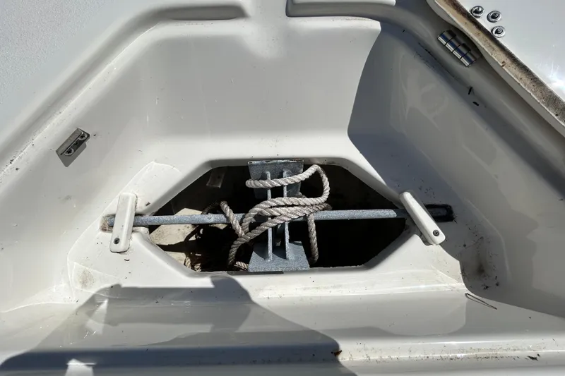 Slide: The Image of Anchor storage compartment on 2022 Key West 219 FS boat, featuring secured rope and anchor. - 101