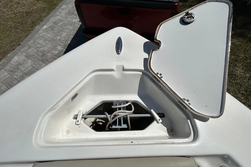 Slide: The Image of Open anchor compartment on 2022 Key West 219 FS boat, showing rope and anchor. - 102