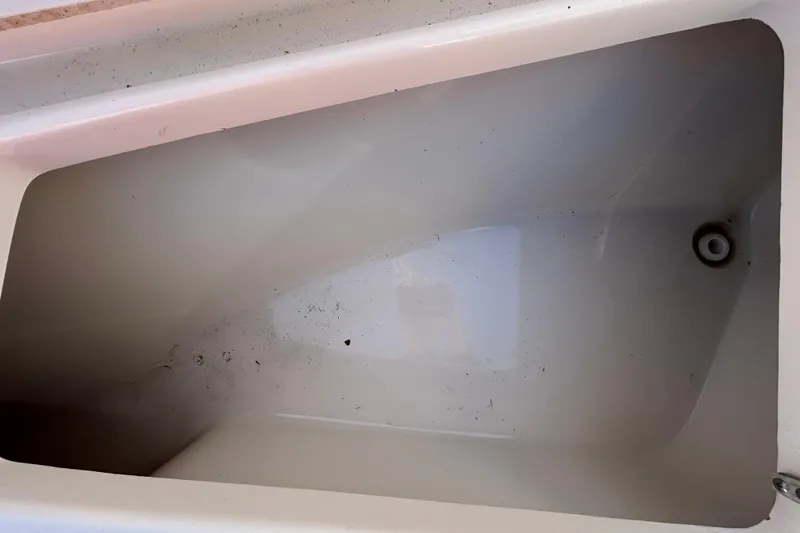 Slide: The Image of 2022 Key West 219 FS boat storage compartment, showing interior details and cleanliness. - 106