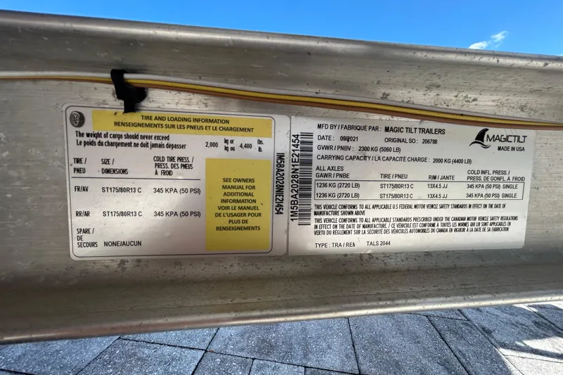 Slide: The Image of Label on Magic Tilt trailer showing tire and loading information, 2022 Key West 219 FS. - 111