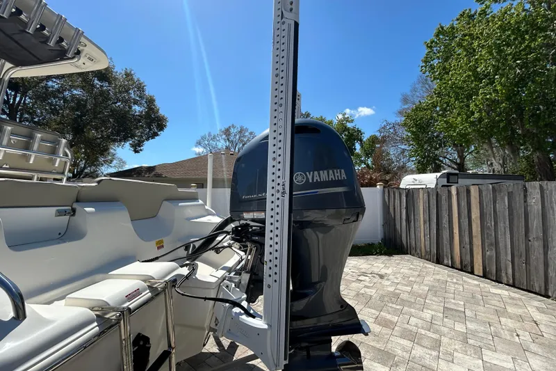 Slide: The Image of 2022 Key West 219 FS boat with Yamaha outboard motor, parked on a sunny day. - 12