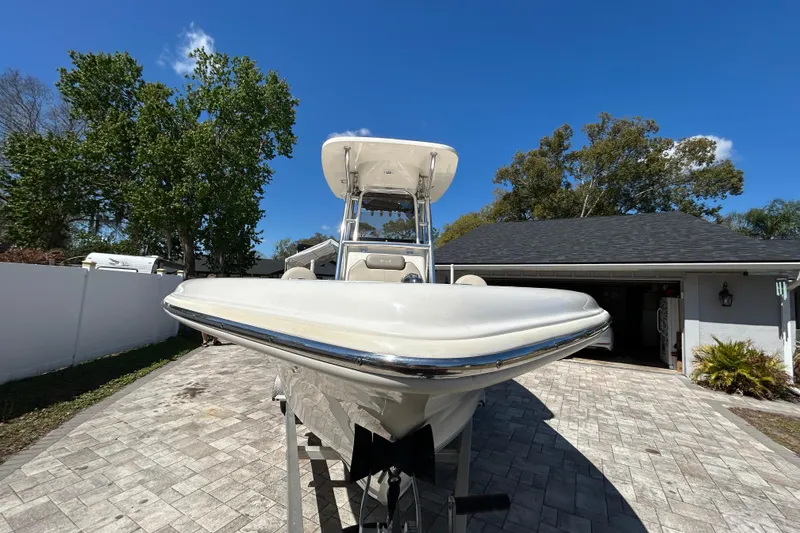 Slide: The Image of 2022 Key West 219 FS boat parked on a driveway under a clear blue sky. - 16