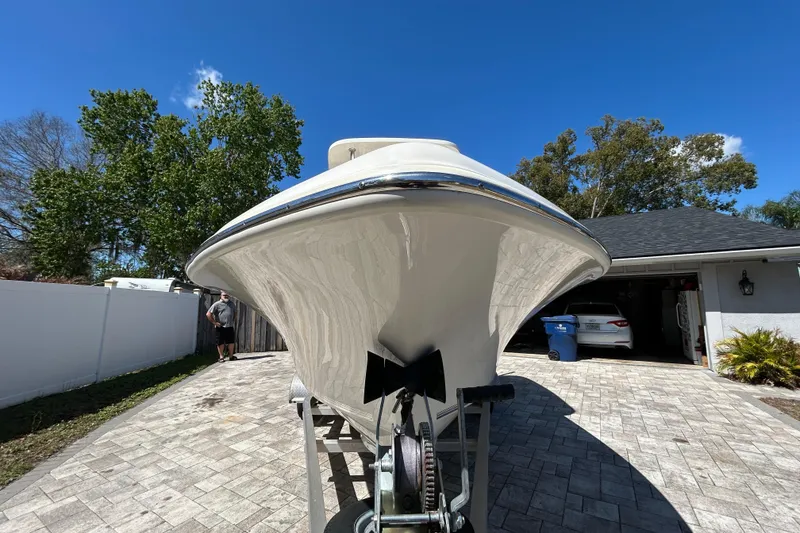 Slide: The Image of 2022 Key West 219 FS boat on driveway under clear blue sky. - 17
