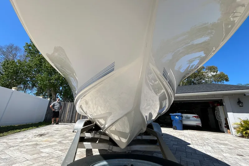 Slide: The Image of 2022 Key West 219 FS boat on trailer in driveway, sunny day. - 18