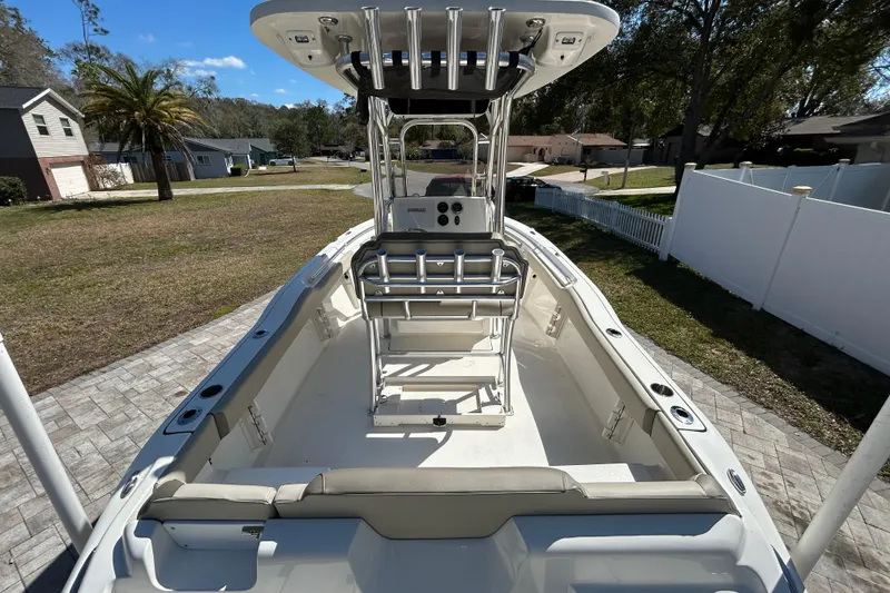 Slide: The Image of 2022 Key West 219 FS boat with T-top, parked in residential driveway. - 20