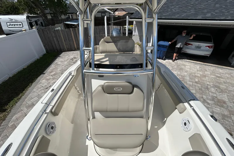 Slide: The Image of 2022 Key West 219 FS boat with seating and T-top in a driveway setting. - 44