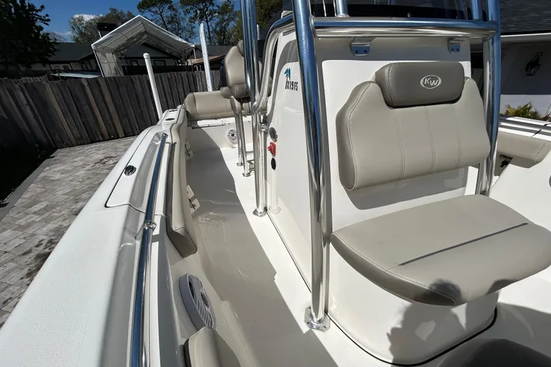 Slide: The Image of 2022 Key West 219 FS boat interior with seating and console, parked in driveway. - 48