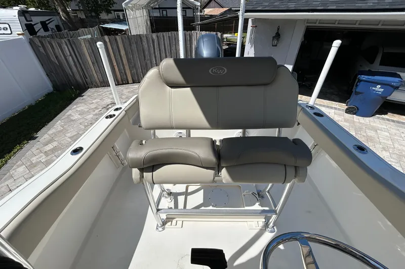 Slide: The Image of 2022 Key West 219 FS boat interior with cushioned seating and steering wheel. - 50