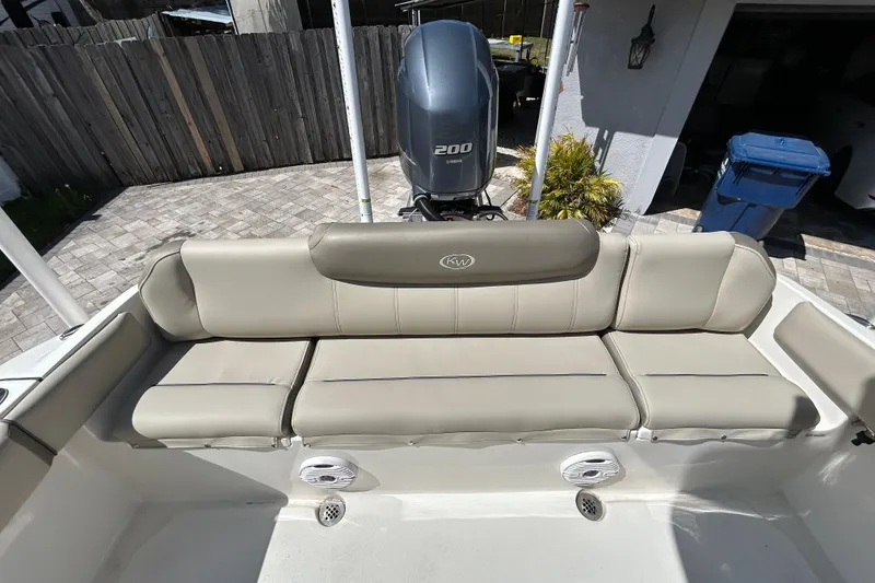 Slide: The Image of 2022 Key West 219 FS boat with beige seating and Yamaha 200 engine. - 52