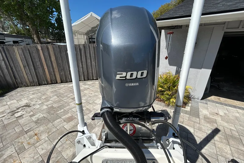 Slide: The Image of 2022 Key West 219 FS boat with Yamaha 200 outboard motor in driveway. - 55