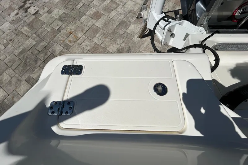 Slide: The Image of 2022 Key West 219 FS boat deck with storage compartment and hinges. - 58