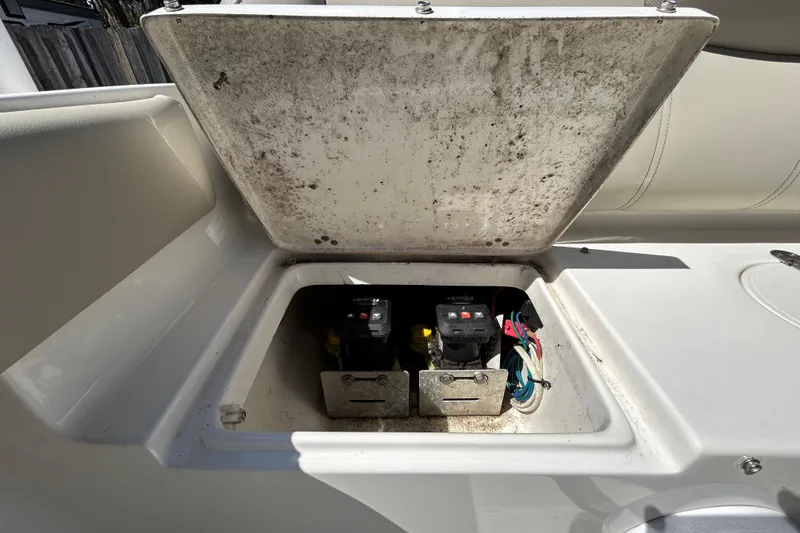 Slide: The Image of Open hatch on 2022 Key West 219 FS boat showing electrical components. - 63