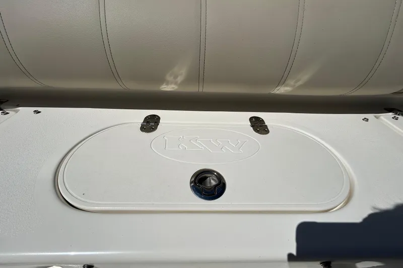 Slide: The Image of 2022 Key West 219 FS boat seat with storage compartment and KW logo. - 66