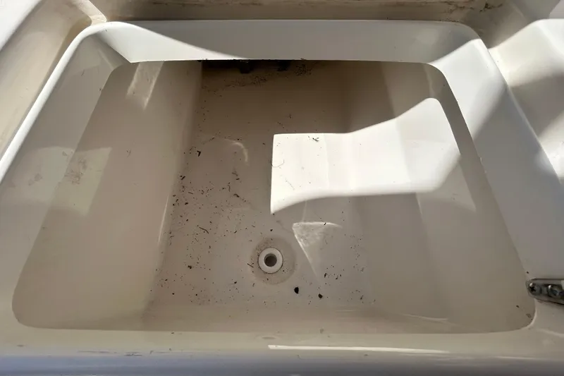 Slide: The Image of 2022 Key West 219 FS boat storage compartment, empty and slightly dirty. - 71