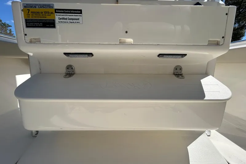 Slide: The Image of 2022 Key West 219 FS boat seating with capacity label, white interior. - 75
