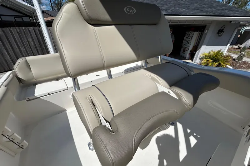 Slide: The Image of 2022 Key West 219 FS boat seating with beige upholstery in a sunny setting. - 80