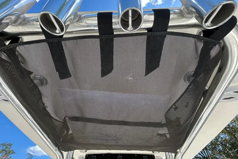 Slide: The Image of 2022 Key West 219 FS boat with rod holders and mesh storage on T-top. - 81