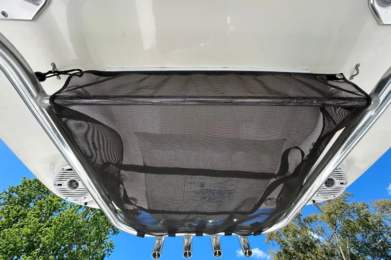 Slide: The Image of 2022 Key West 219 FS boat with mesh storage and rod holders, viewed from below. - 82