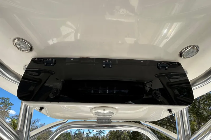 Slide: The Image of 2022 Key West 219 FS boat's T-top with mounted black electronics box. - 83