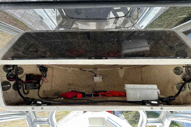 Slide: The Image of 2022 Key West 219 FS boat storage compartment with wiring and equipment. - 85