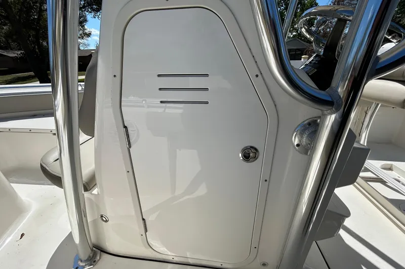Slide: The Image of 2022 Key West 219 FS boat console with stainless steel railings and storage compartment. - 86