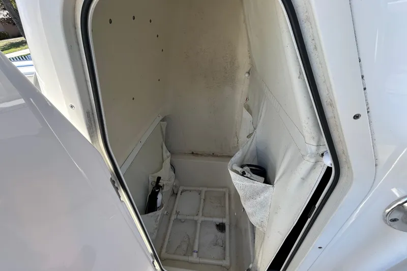 Slide: The Image of 2022 Key West 219 FS boat storage compartment with open door and interior view. - 88