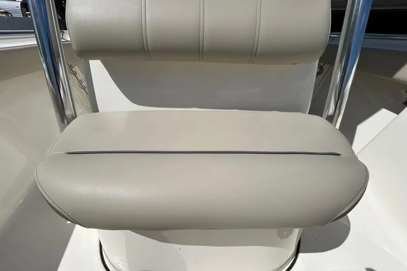 Slide: The Image of 2022 Key West 219 FS boat seat with beige upholstery and stainless steel frame. - 89