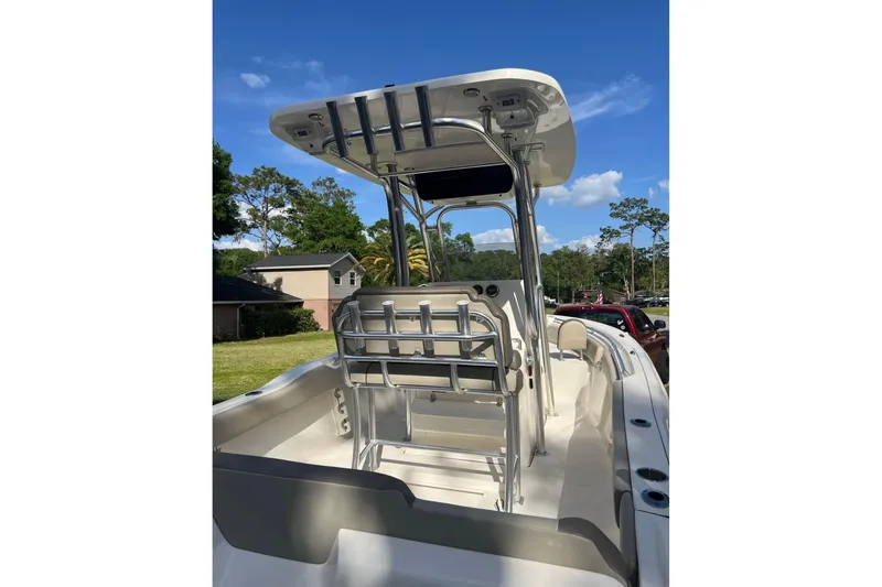 Slide: The Image of 2022 Key West 219 FS boat with T-top and seating, parked outdoors. - 9