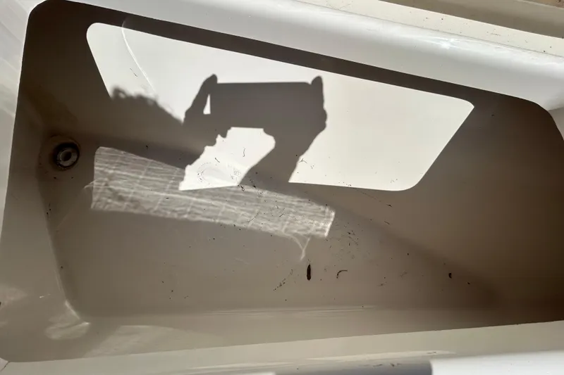 Slide: The Image of Shadow of a person taking a photo inside a Key West 219 FS boat, 2022 model. - 99