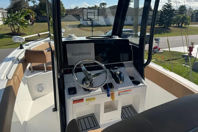 Slide: The Image of 2023 Sea Hunt Ultra 239 SE boat dashboard with Garmin navigation system. - 12