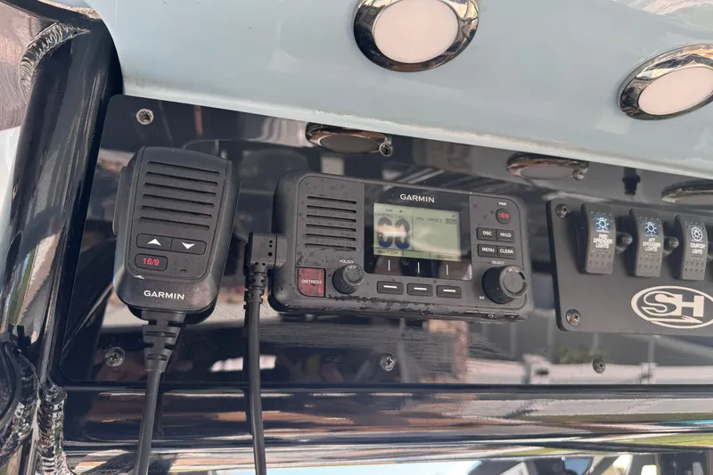 Slide: The Image of Garmin marine radio and controls on 2023 Sea Hunt Ultra 239 SE boat dashboard. - 17